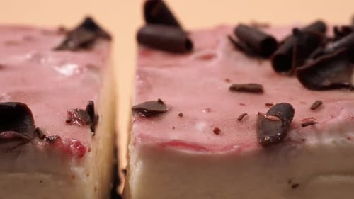 Delicious pink cake dessert with chocolate shavings