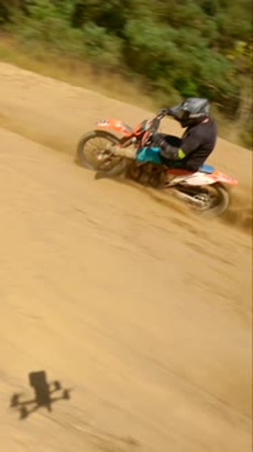 Man Riding Dirt Bike on Rural Motocross Track