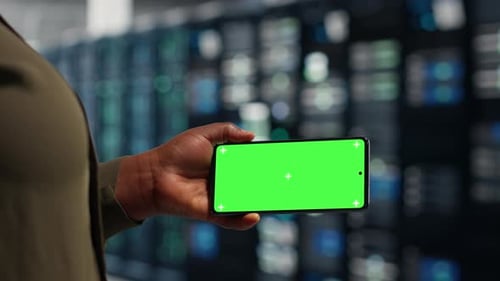 Data Center Data Center Admin Runs Equipment Checkups Using Green Screen Laptop