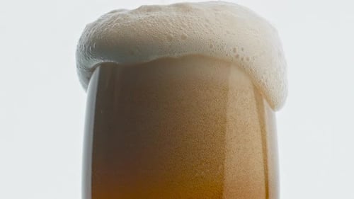 Ale Glass Foam Overflows Closeup. Cold Craft Light Beer Super Slow Motion. Hop Extract Beverage C...