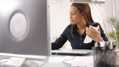 Woman in Office Looking at Receipts 20s