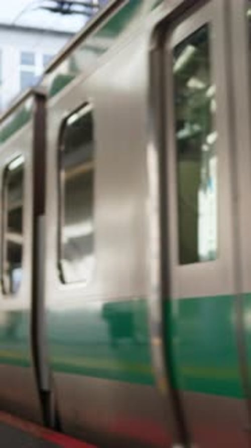 Close up of a subway arriving at the station in Tokyo, Japan. Vertical