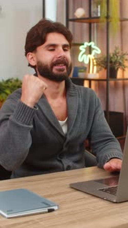 Man Working on Laptop at Desk Indoors