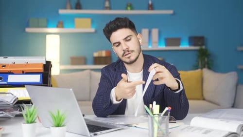 Young Adult Man Having Video Conference at Home