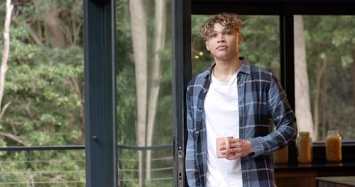 Young Adult with Coffee by Window