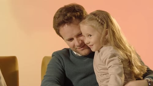 Loving Father Holding Daughter in Heartwarming Embrace
