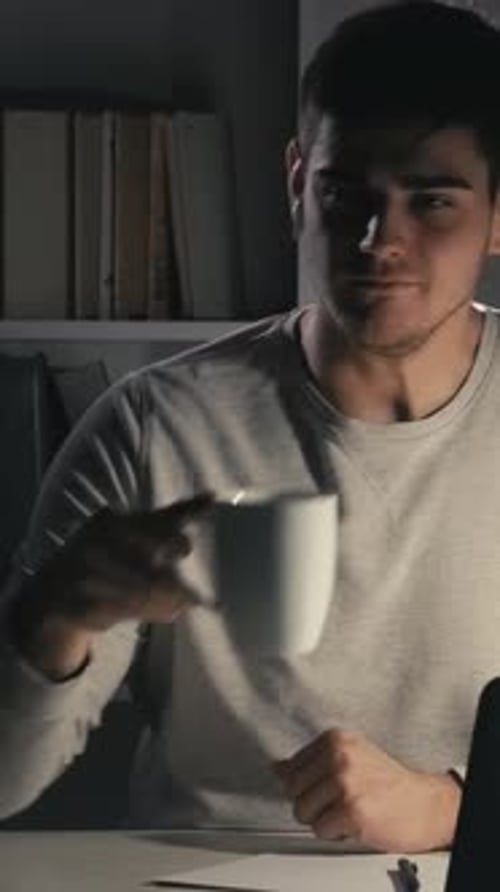 Young Adult Working Late on Laptop at Home