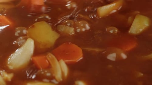 Hungarian Goulash Soup Cooking Closeup in Pot Chef Cook Traditional Polish or Zech Soup in