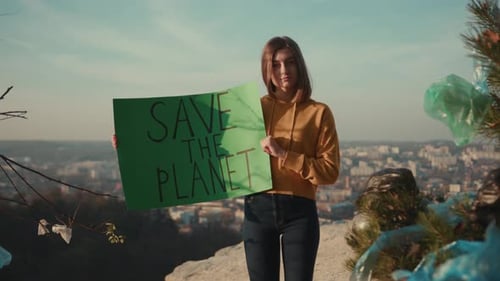 At Sunlight Woman Activist Holding Encouraging Green Poster Save the Planet Standing Background