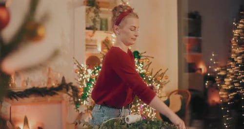 Woman Crafting Christmas Wreath Indoors