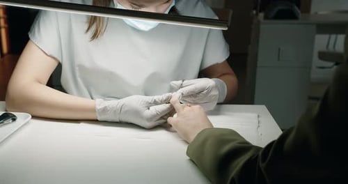 Manicurist Giving Manicure to Client in Salon