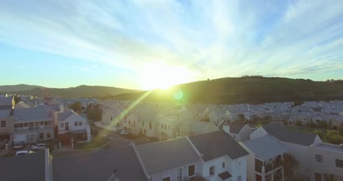 Sunrise or Sunset Over Suburban Neighborhood Aerial View