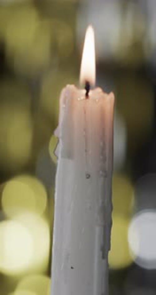 Burning Candle Flame Close Up on Dark Background