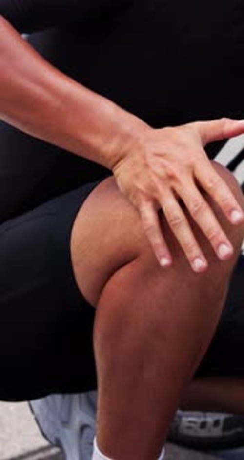 Man Massaging Knee After Cycling Training Outdoors