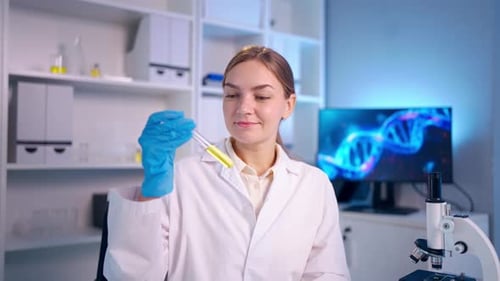 Portrait of Caucasian female scientist in white lab coat in laboratory.