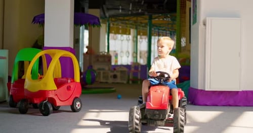 Boy Driving a Pedal Car Child Having Fun Riding a Car in an Amusement Park