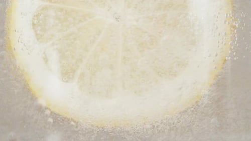 Lemon Slice Immersed in Sparkling Refreshing Water