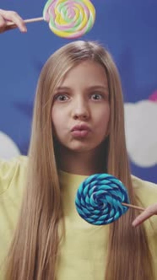 Cheerful Girl with Colorful Sweets Studio Shot of Cheerful Girl Holding Different Colorful Candy
