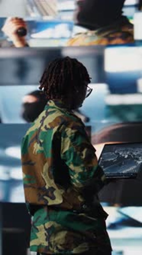 Woman in Camouflage Using Laptop in Control Room
