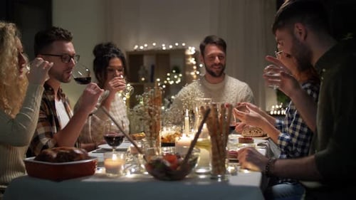 Friends Toasting at Warm Candlelit Dinner Gathering