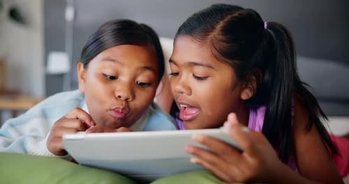 Two Children Using Tablet Together Indoors