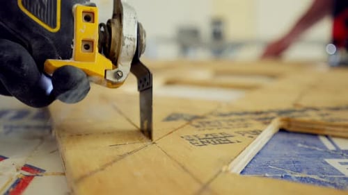 Electrical Saw Electric Power Carpentry Oscillating Tool Man is Cutting Plywood on the Construction