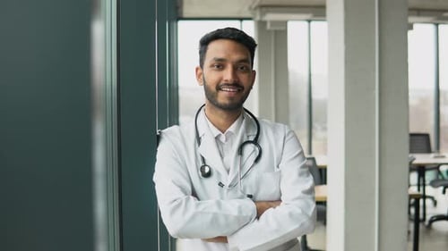 Smiling Doctor With Stethoscope in Modern Office