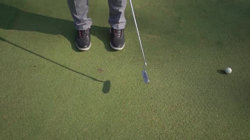 closeup to the ball, golfer hits the ball with stick