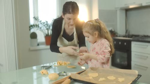 Woman and Child Bake Cookies in Kitchen