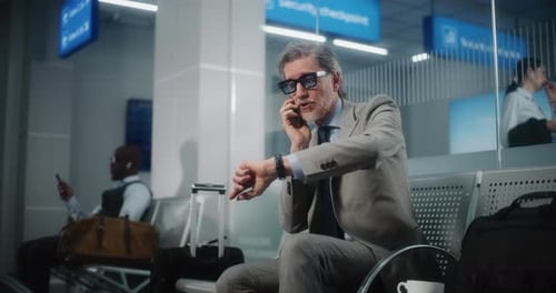 Airport Terminal Successful Man Getting Angry About Canceled or Delayed Flight Talking on Phone