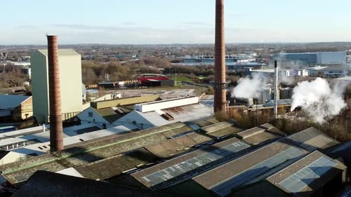 Pilkington glass factory warehouse buildings aerial view descends to industrial town facility