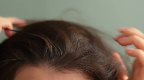 Woman Checking Gray Hair Roots with Fingers