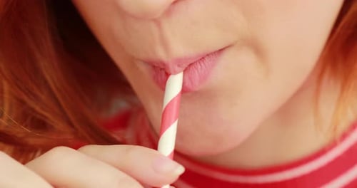 Girl mouth drinking with straw
