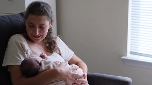 Mother nursing her baby in a chair