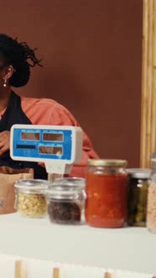 Young Woman Weighing Goods at Grocery Store Counter