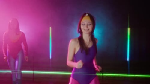 Women in Leotards Exercise in Studio with Neon Lights