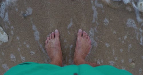 High Angle of Feet of a Man Standing in the Sea