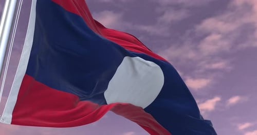 Realistic Flag of Laos Waving Against Cloudy Sky