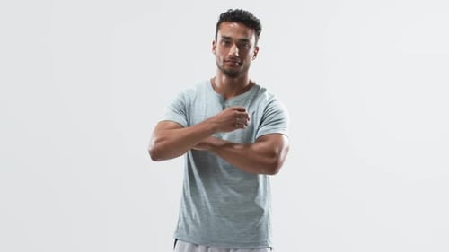 Confident young biracial athlete man posing in a studio on a white background