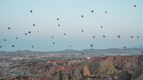 Colorful Hot Air Balloons Float Over Desert Landscape