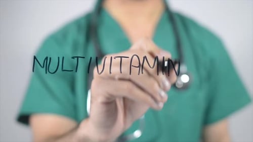 Doctor Writes "Multivitamins" on Clear Surface