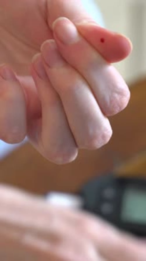 Person Using Blood Glucose Meter Close Up