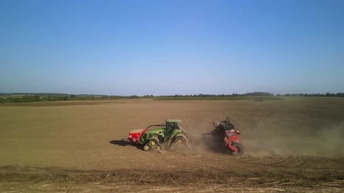 Tractor on the field seeding wheat