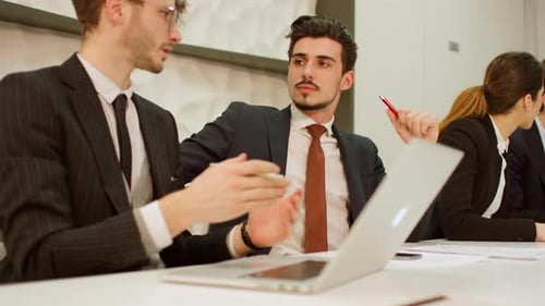 Business professionals in a meeting, engaged in discussion