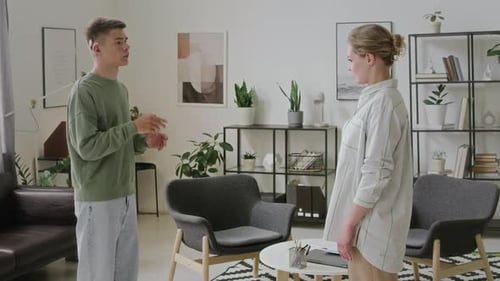 Two People Communicating Using Sign Language in Living Room