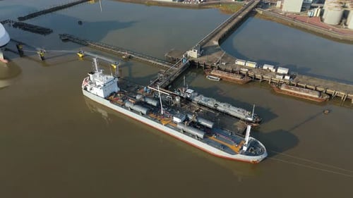 Aerial view of a docked ship near jetties, United Kingdom.