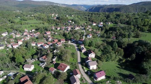 Aerial of a small typical village with mosque in the Bosnian mountains.