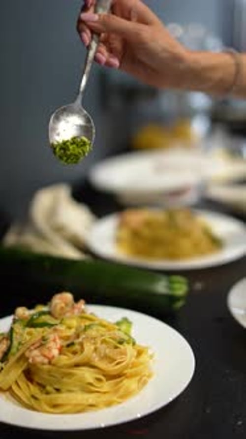 Adding Finishing Touch to Plate of Seafood Pasta