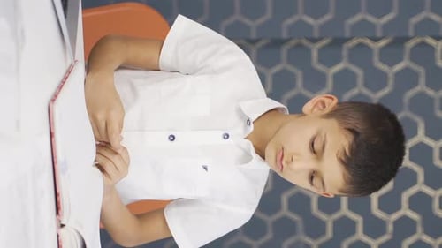 Boy Doing Homework in Vertical Format