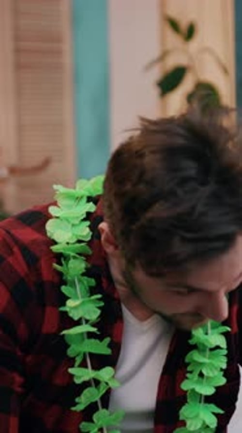 Man Wears Birthday Hat and Party Necklace